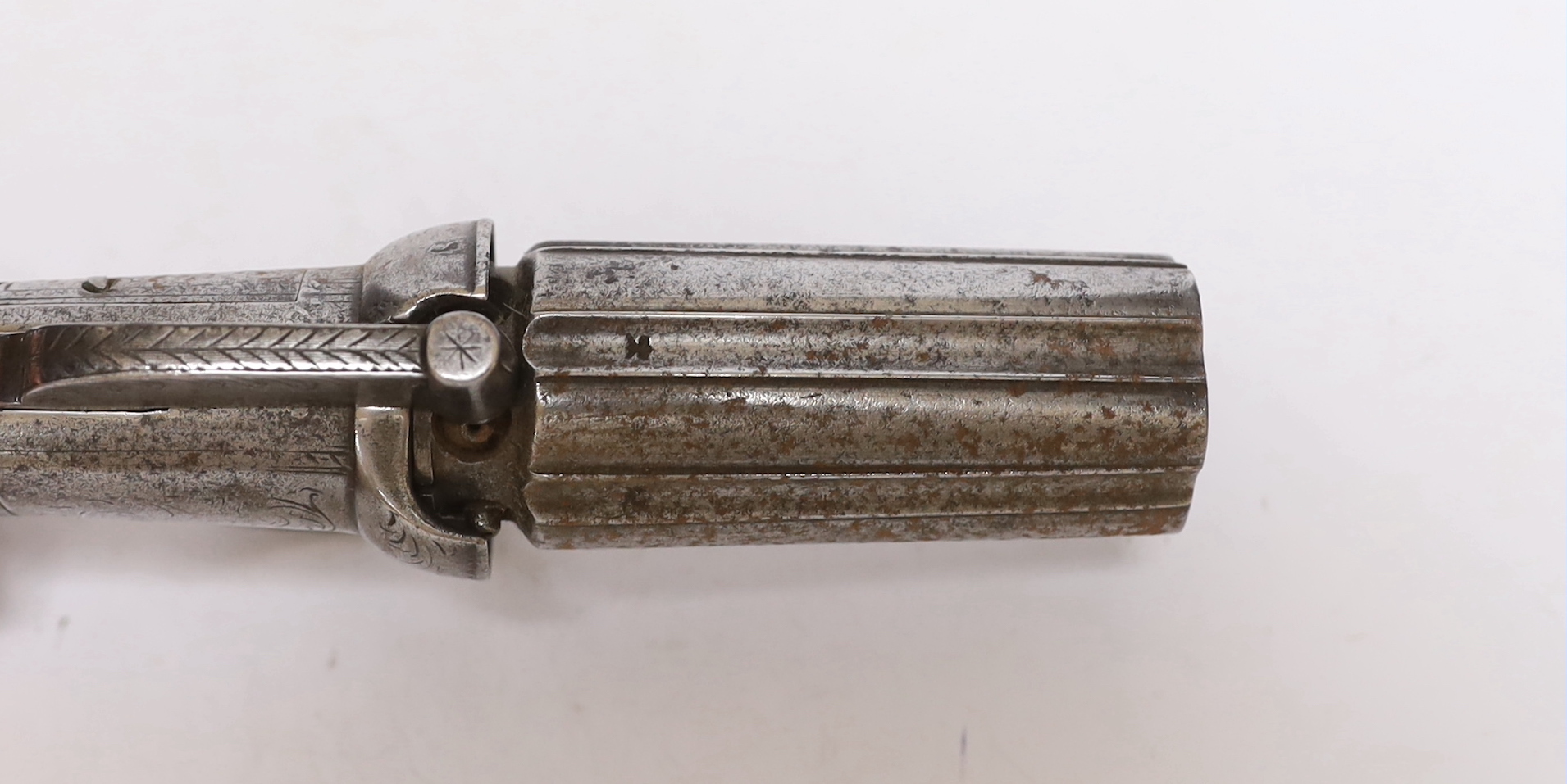 A mid-19th century six shot self-cocking percussion pepper box revolver, with foliate engraved frame, fluted barrels and two piece walnut grips, barrel 7.5cm